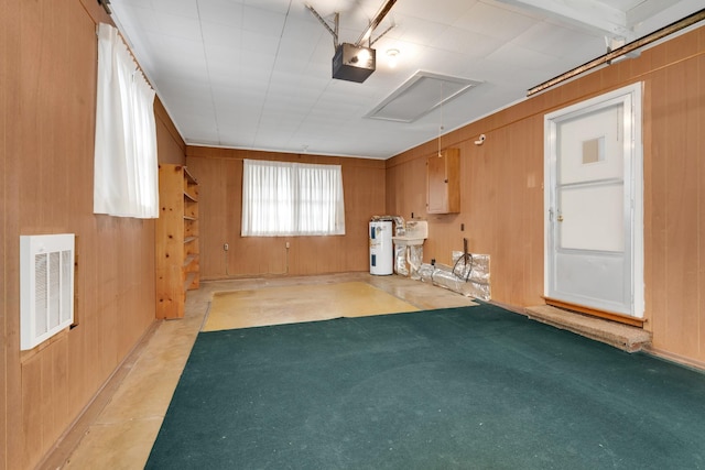 interior space featuring water heater and wooden walls