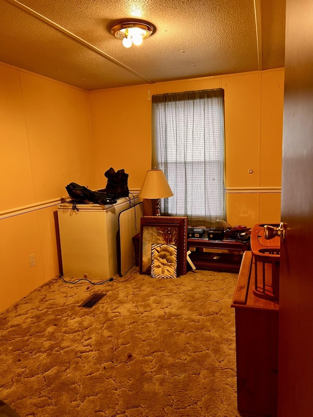 carpeted bedroom featuring a textured ceiling