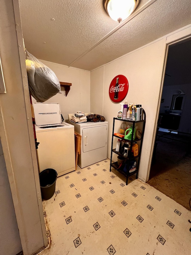 laundry room featuring independent washer and dryer and a textured ceiling