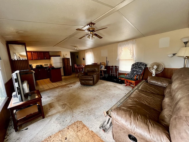 living room featuring lofted ceiling and ceiling fan