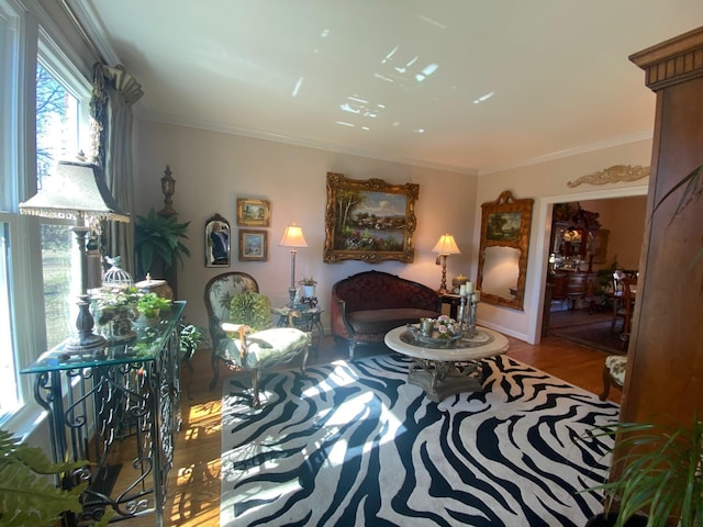 sitting room featuring crown molding and wood finished floors