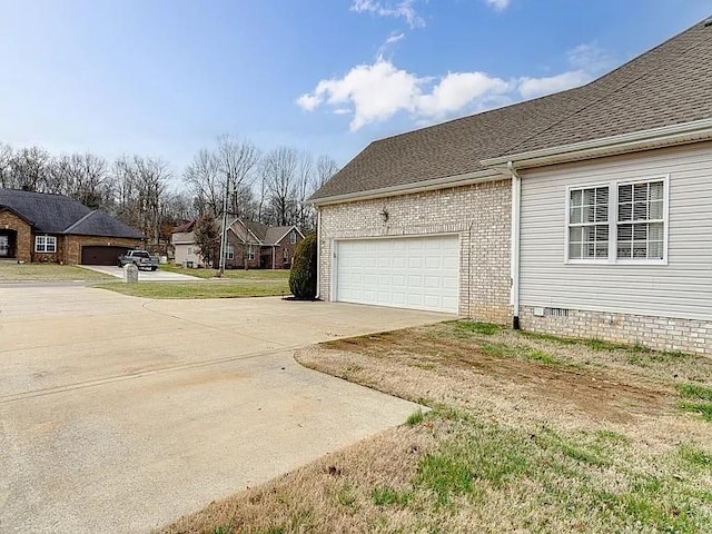 view of side of home with a garage