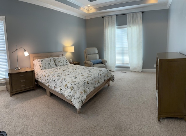 carpeted bedroom featuring crown molding and a tray ceiling