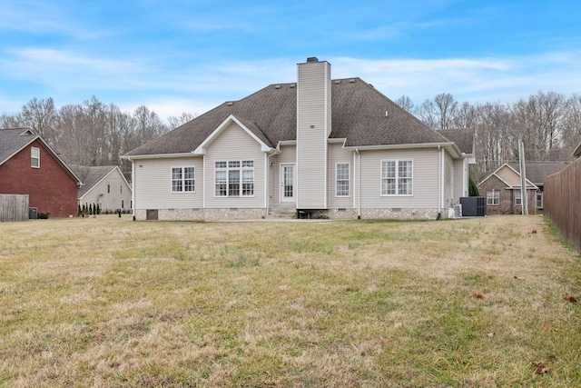 rear view of property featuring central AC unit and a yard