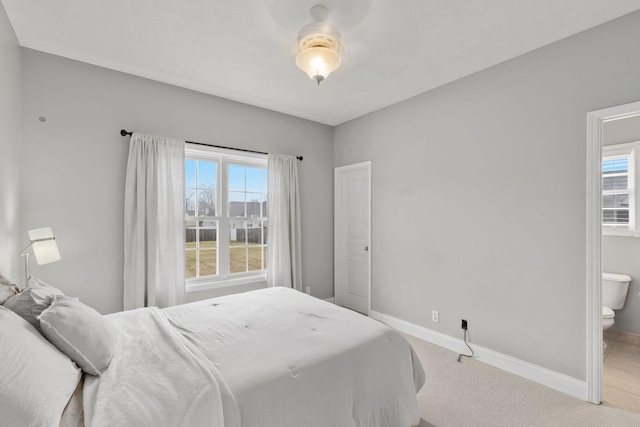 carpeted bedroom with ensuite bathroom