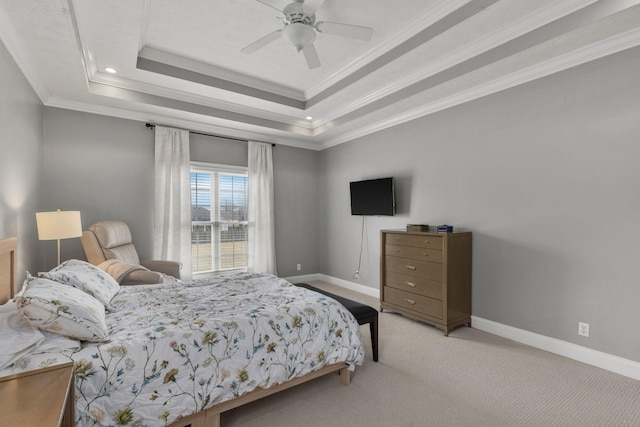 carpeted bedroom with crown molding, ceiling fan, and a tray ceiling