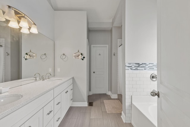 bathroom featuring vanity and a tub