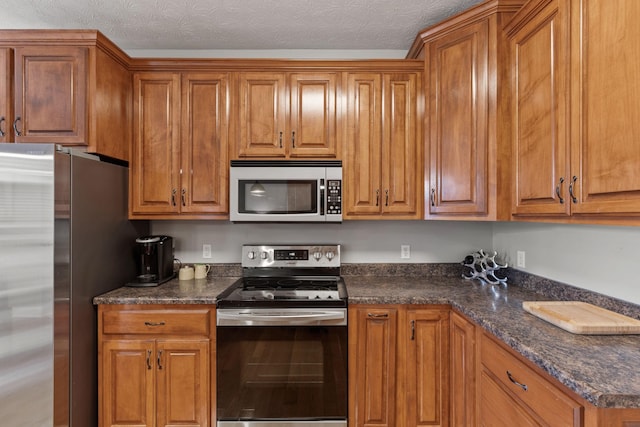 kitchen featuring stainless steel appliances and a textured ceiling