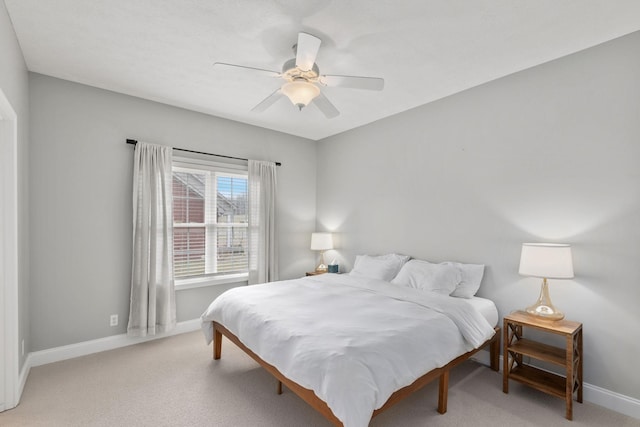 bedroom featuring light colored carpet and ceiling fan