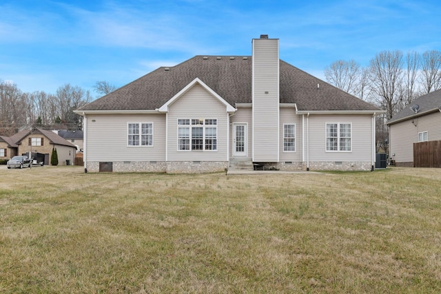 back of house with central AC and a lawn