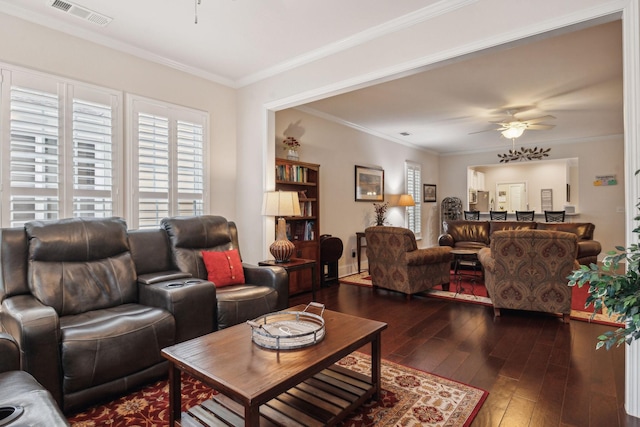 living room with ornamental molding, dark hardwood / wood-style floors, and ceiling fan