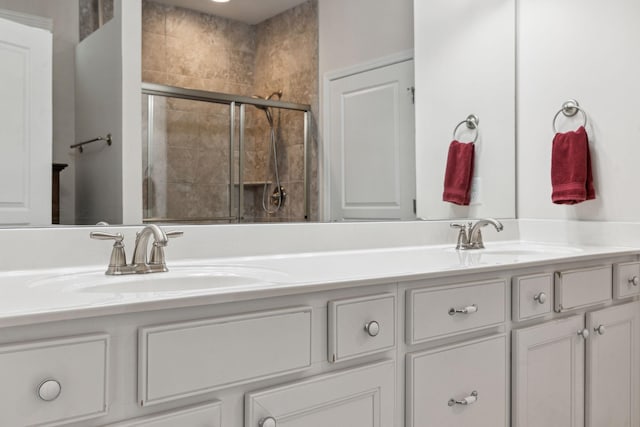 bathroom featuring vanity and a shower with shower door