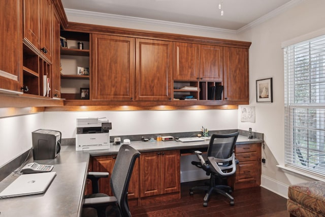 office area with dark wood-type flooring, ornamental molding, a healthy amount of sunlight, and built in desk