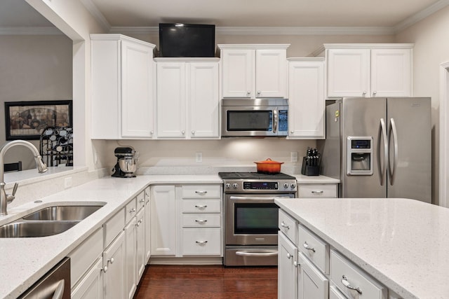 kitchen featuring sink, white cabinetry, ornamental molding, stainless steel appliances, and light stone countertops