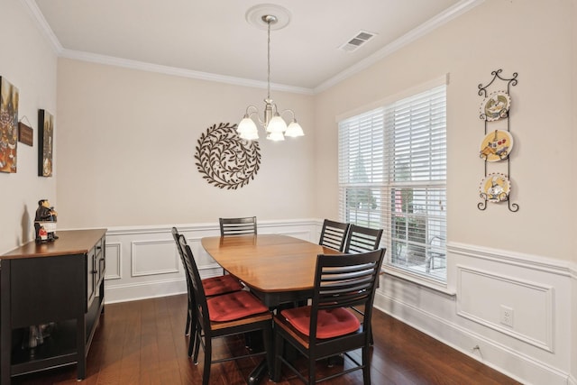 dining space with a notable chandelier, ornamental molding, and dark hardwood / wood-style floors