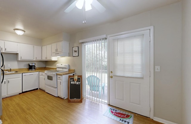 kitchen featuring light wood-style floors, white appliances, white cabinetry, and a sink