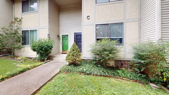 property entrance with stucco siding