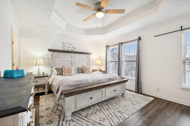 bedroom with ornamental molding, dark hardwood / wood-style flooring, a raised ceiling, and a textured ceiling