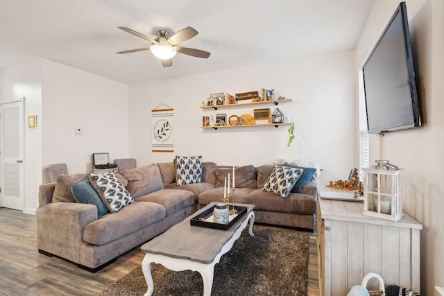 living room featuring hardwood / wood-style flooring and ceiling fan