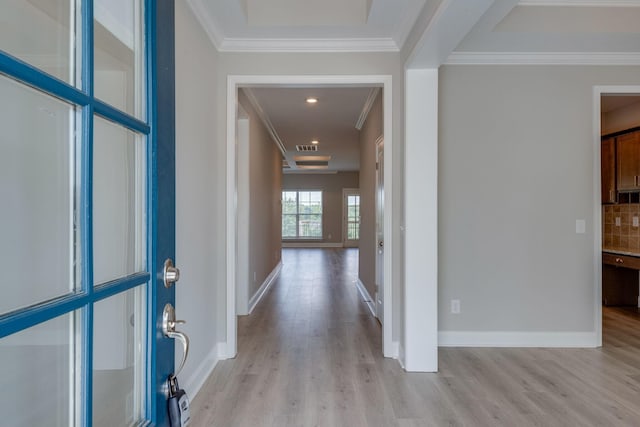 corridor featuring ornamental molding and light hardwood / wood-style floors