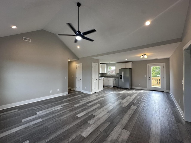 unfurnished living room featuring lofted ceiling, dark hardwood / wood-style floors, and ceiling fan