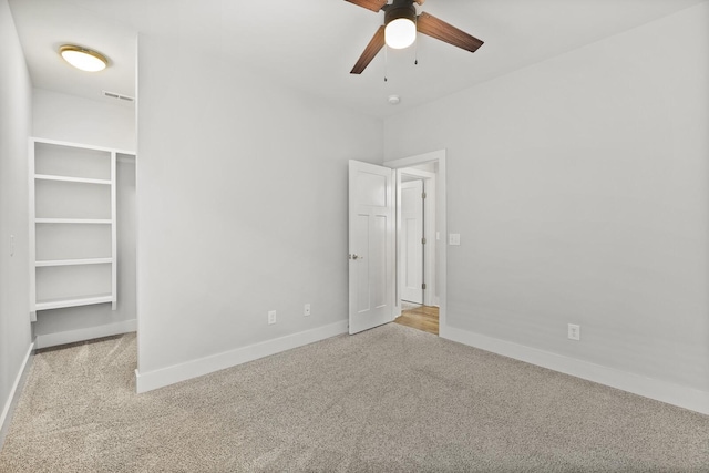 unfurnished bedroom featuring light colored carpet and ceiling fan