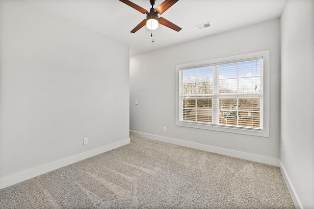 unfurnished room featuring ceiling fan and carpet