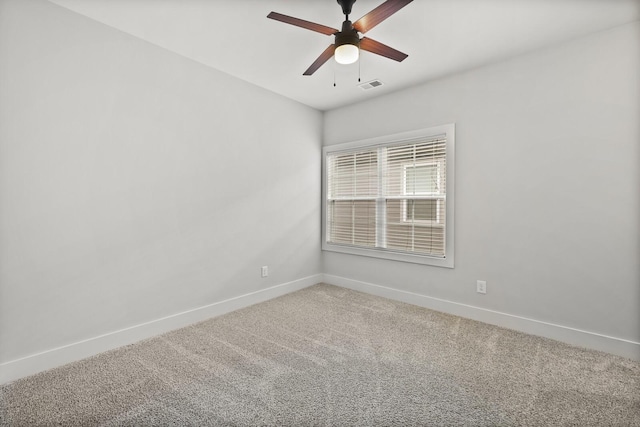 carpeted spare room with ceiling fan