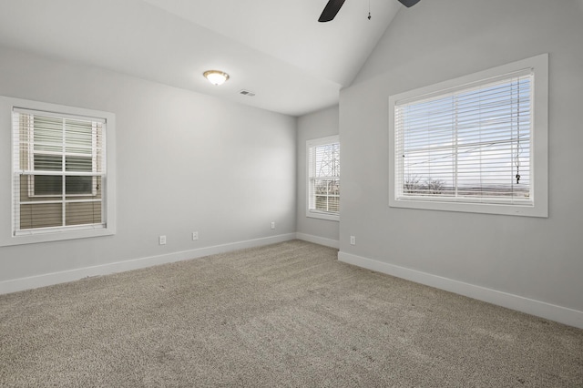 spare room featuring vaulted ceiling, ceiling fan, and carpet flooring