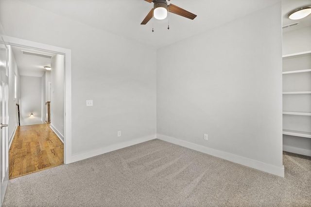 carpeted spare room featuring ceiling fan