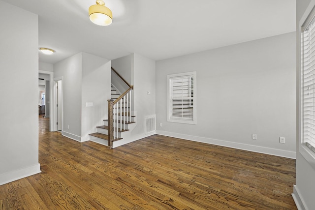 spare room featuring dark wood-type flooring and a wealth of natural light