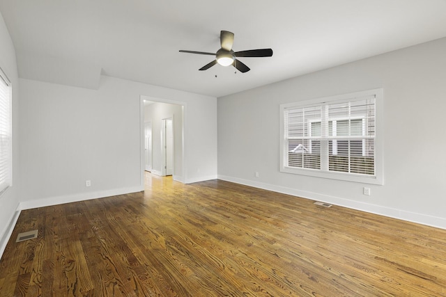 spare room with hardwood / wood-style floors, a wealth of natural light, and ceiling fan