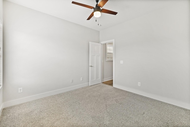 carpeted spare room with ceiling fan