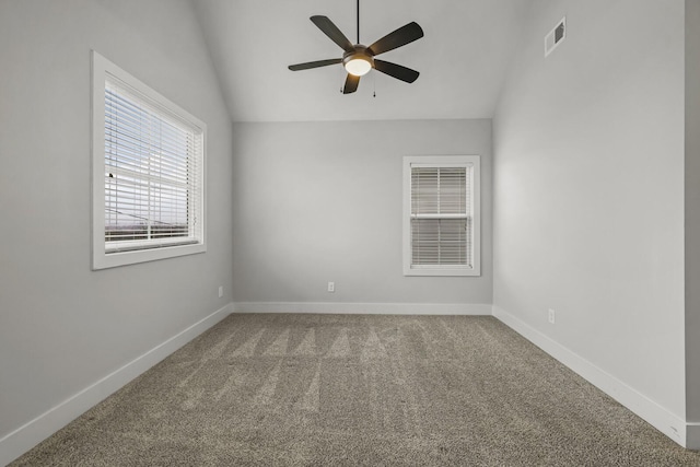 carpeted empty room with ceiling fan and lofted ceiling