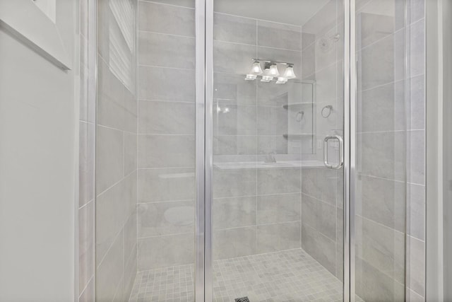 bathroom featuring a shower with shower door