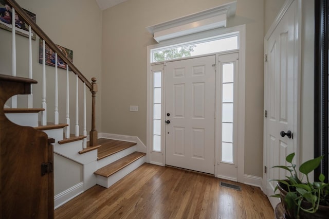 entryway with hardwood / wood-style flooring