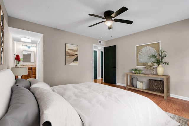 bedroom featuring ceiling fan, connected bathroom, and light hardwood / wood-style floors