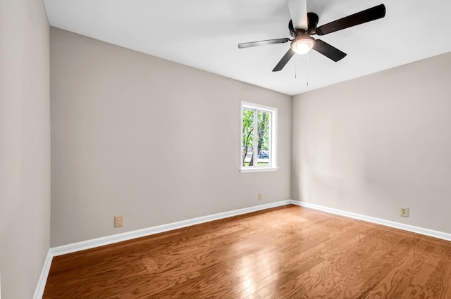 spare room with ceiling fan and wood-type flooring