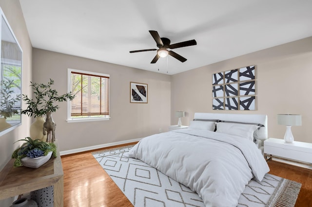 bedroom with hardwood / wood-style floors and ceiling fan