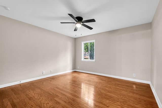 unfurnished room with ceiling fan and hardwood / wood-style floors