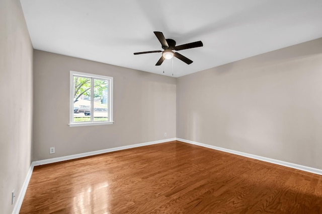 spare room featuring wood-type flooring and ceiling fan