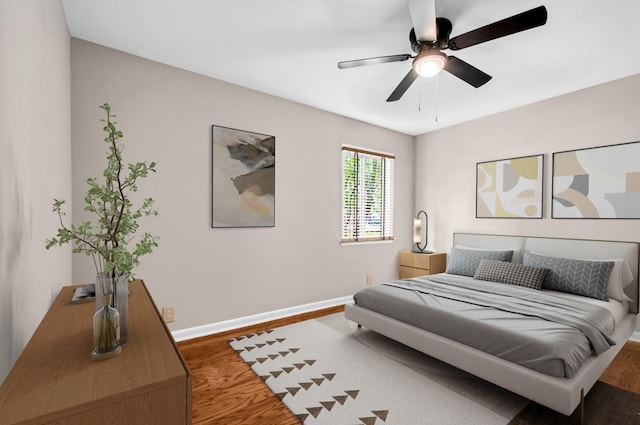 bedroom with ceiling fan and wood-type flooring