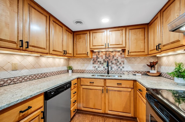 kitchen with extractor fan, appliances with stainless steel finishes, sink, decorative backsplash, and light stone countertops