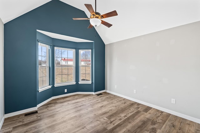 unfurnished room with light wood-type flooring, visible vents, baseboards, and a ceiling fan