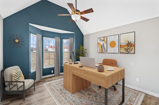 home office featuring light wood-style flooring, vaulted ceiling, baseboards, and ceiling fan