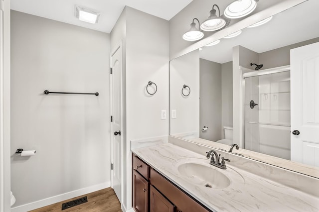 bathroom featuring a stall shower, baseboards, visible vents, and toilet