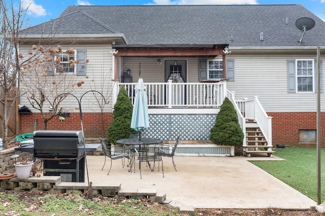 rear view of property featuring a patio and a porch