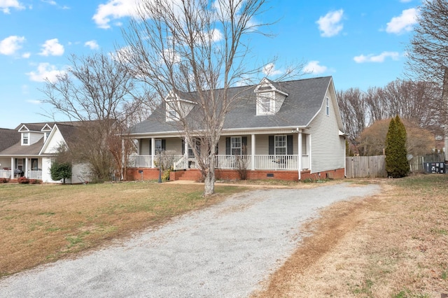 cape cod home with a front yard and covered porch