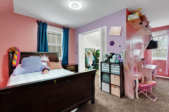 bedroom featuring a spacious closet and light colored carpet