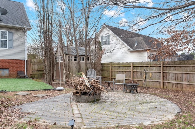 view of patio / terrace featuring a shed and an outdoor fire pit